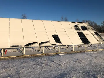 A solar panel partially covered with snow. Photo credit: Mari Benedikte Øgaard