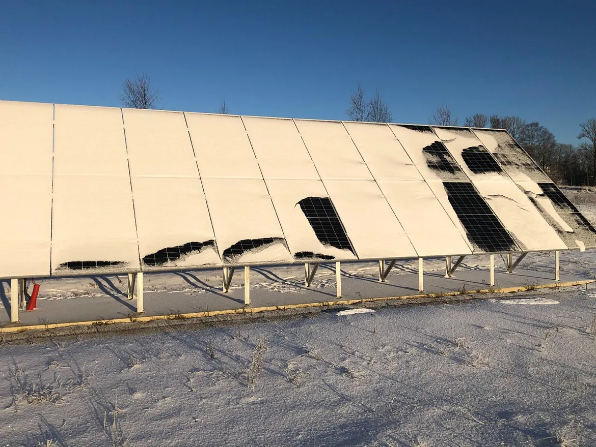 A solar panel partially covered with snow. Photo credit: Mari Benedikte Øgaard