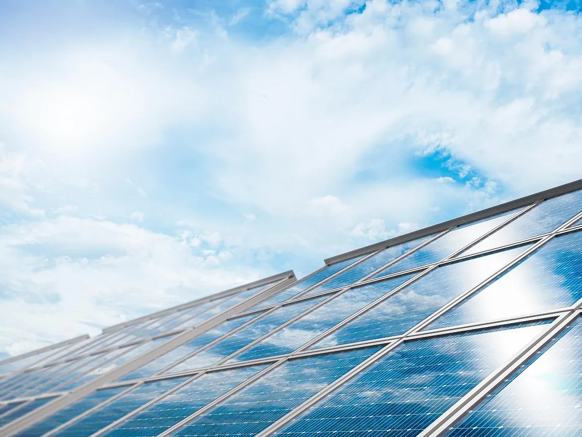 solar panels with clouds above